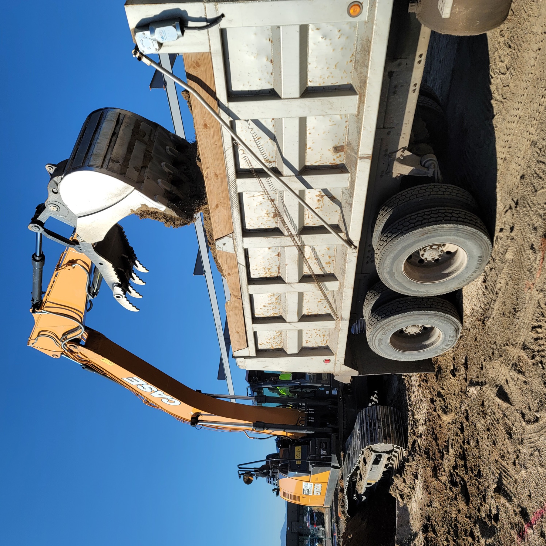 Excavator loading material into a dump truck